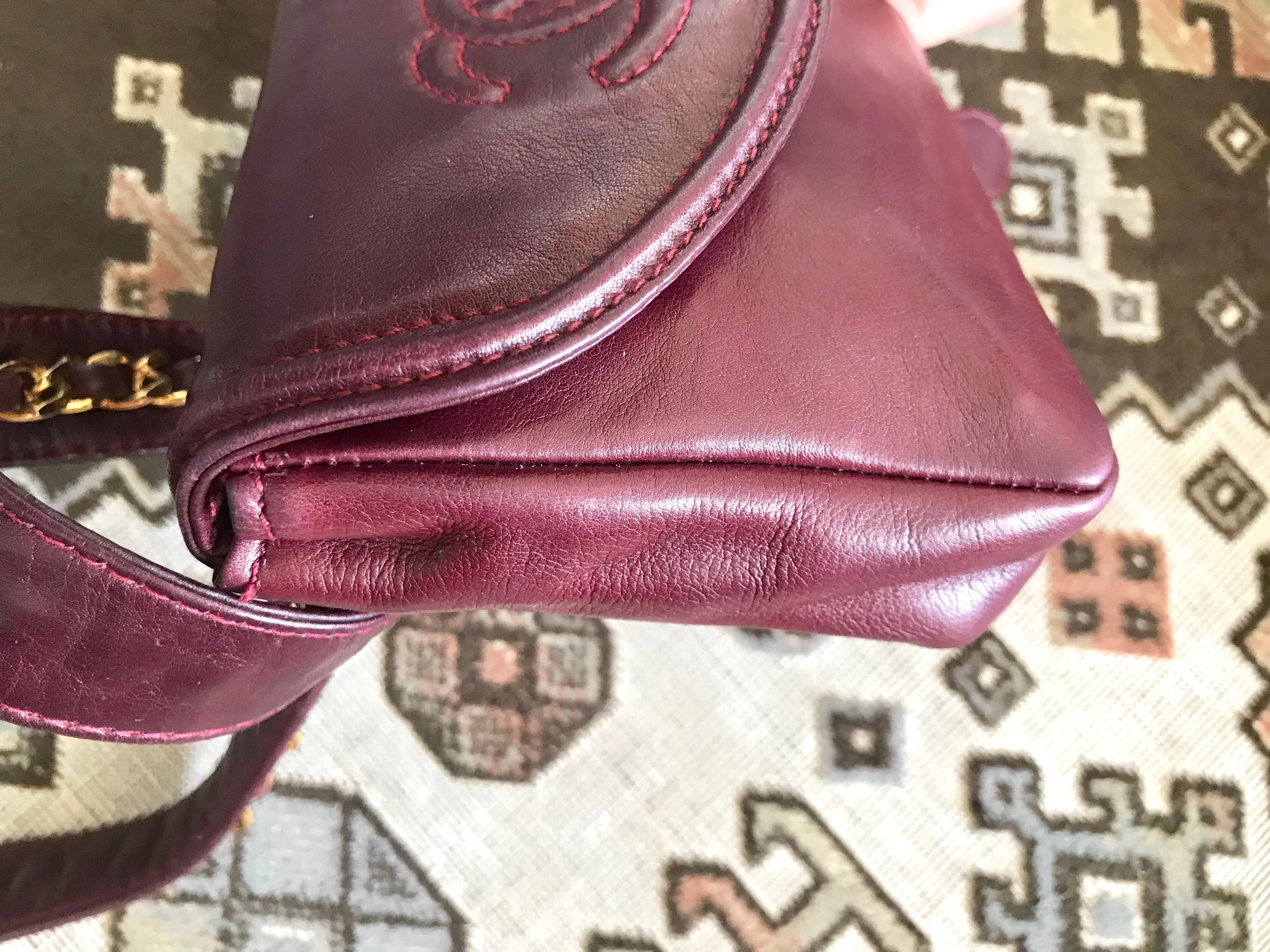 Vintage CHANEL wine fanny pack, leather belt bag with detachable chain belt and CC stitch mark on flap.  Fits 29.5" -32.6"