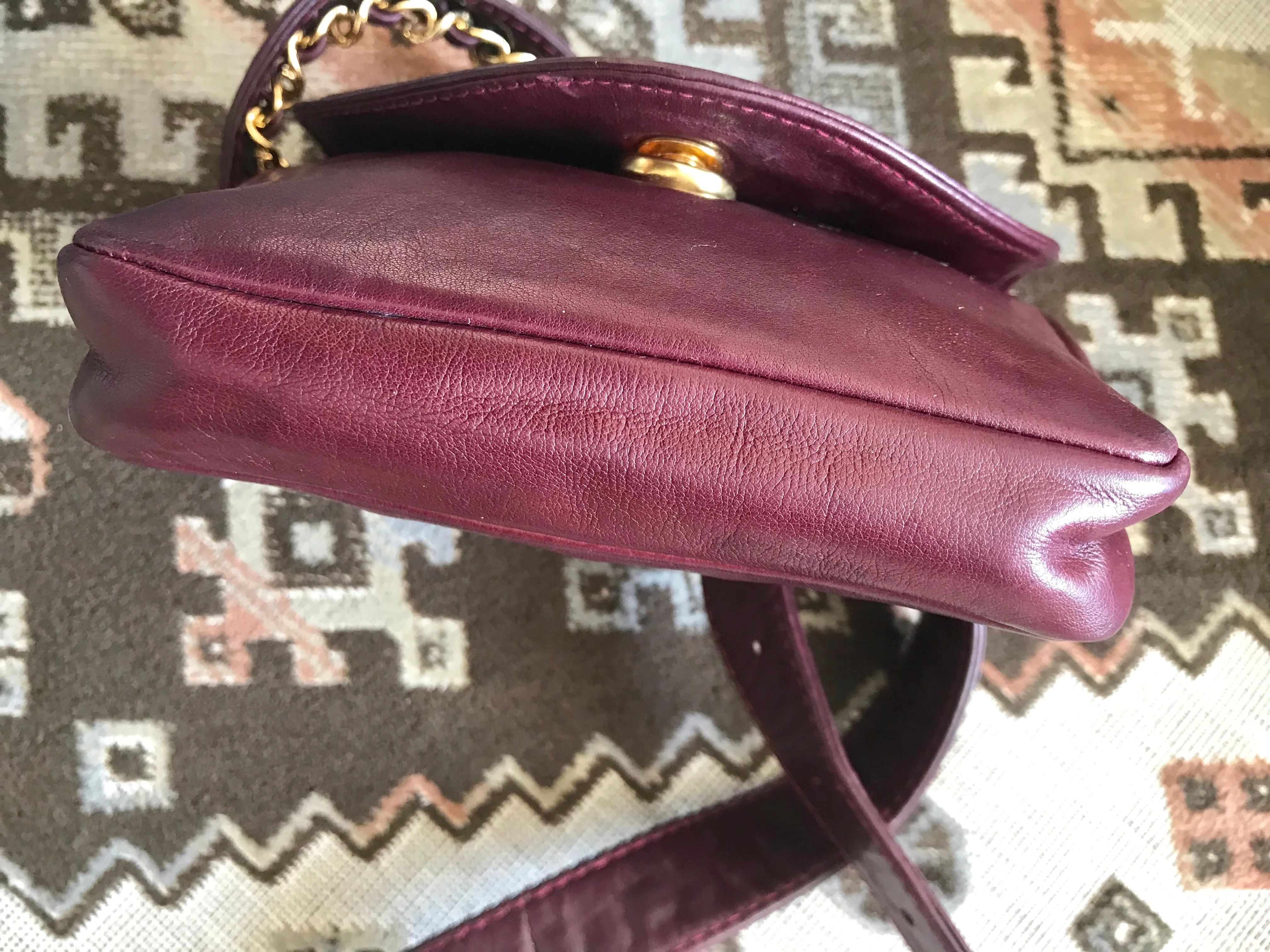 Vintage CHANEL wine fanny pack, leather belt bag with detachable chain belt and CC stitch mark on flap.  Fits 29.5" -32.6"