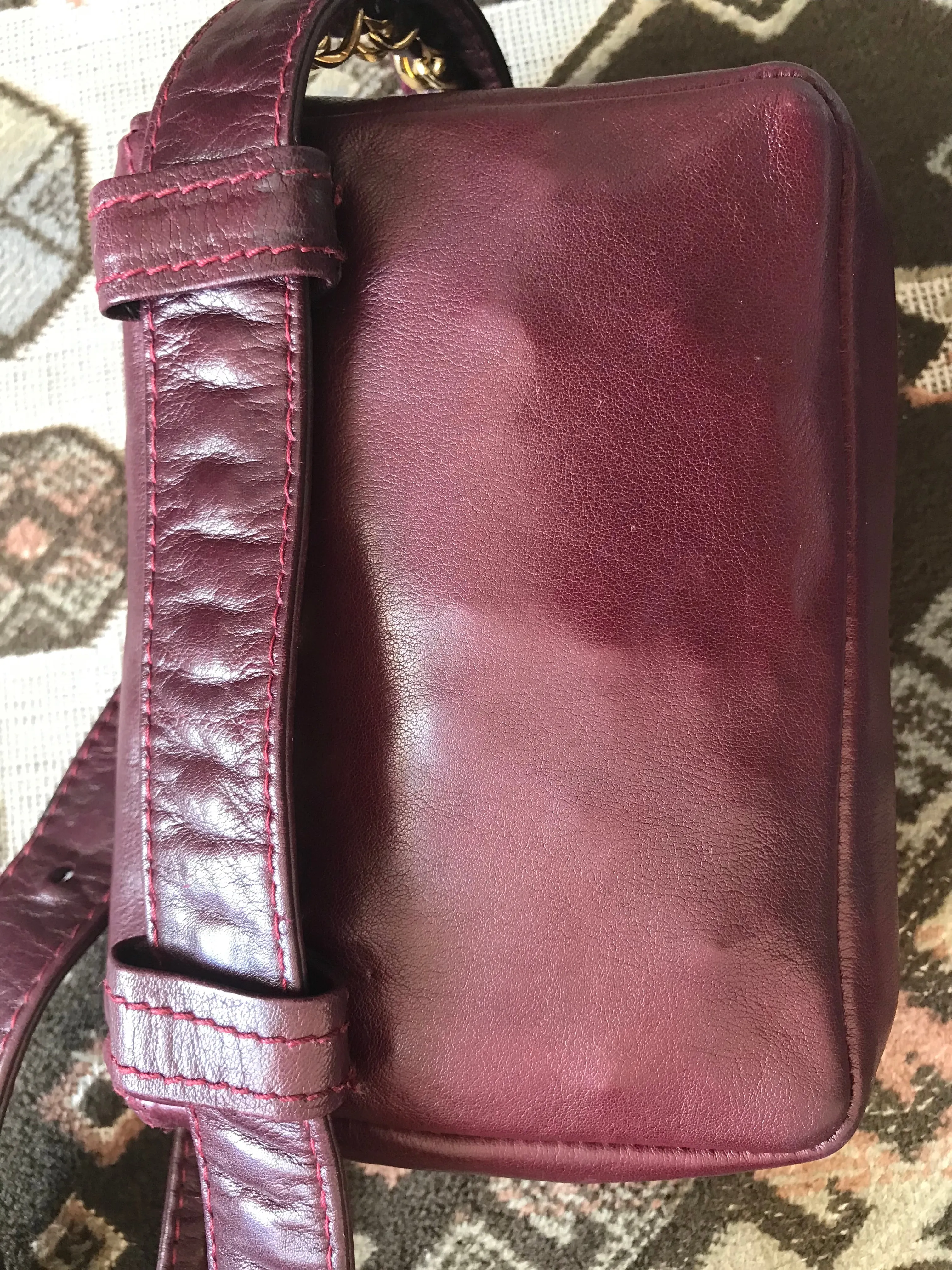 Vintage CHANEL wine fanny pack, leather belt bag with detachable chain belt and CC stitch mark on flap.  Fits 29.5" -32.6"